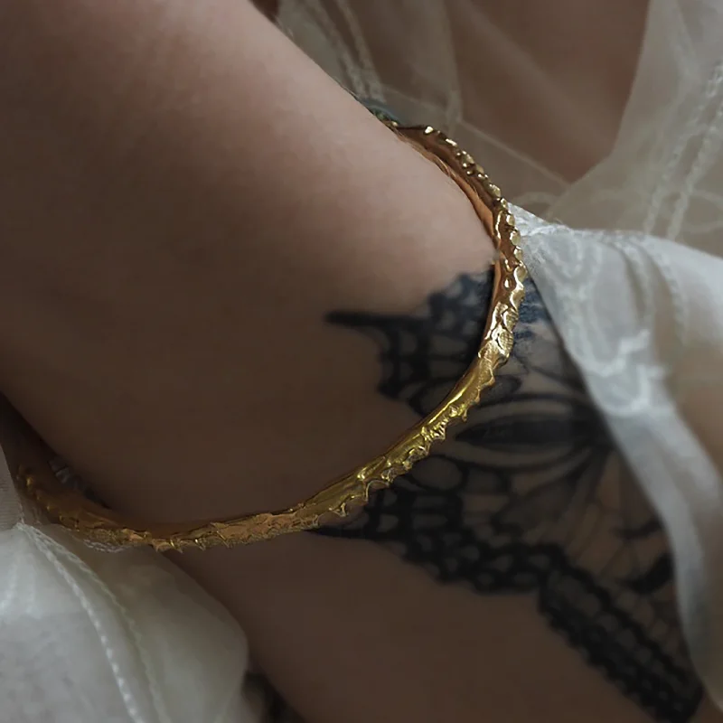 Solid Gold Bangles with Intricate Floral Engravings for a Luxurious LookOssicle Alterum Bangle Solid Gold Bangles with Intricate Floral Engravings for a Luxurious LookOssicle Alterum Bangle
